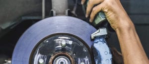 Mechanic working on brakes.