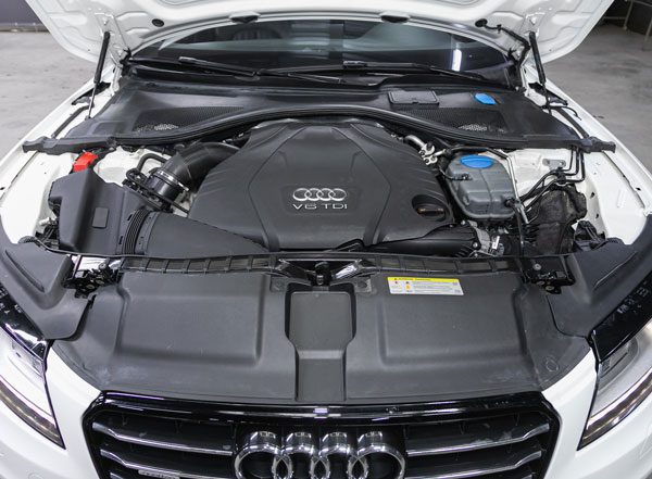 White Audi Sedan with its hood up showing the engine