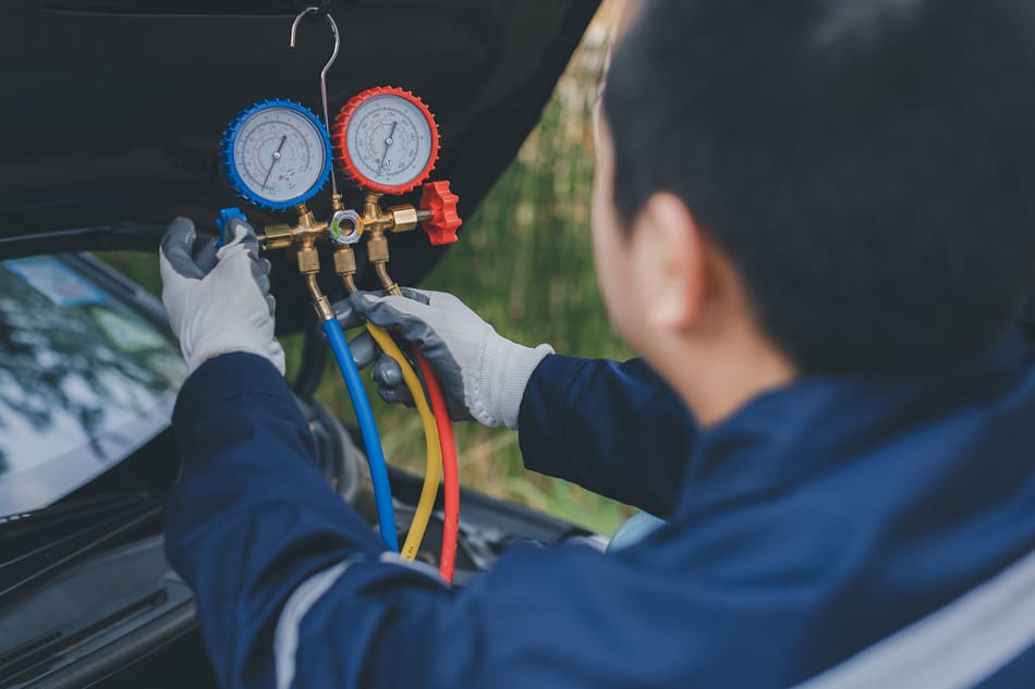 Auto-mechanic-monitor-to-check-and-fixed-car-air-conditioner-system-in-car-garage-2209790849 Auto mechanic monitor to check and fixed car air conditioner system in car garage. service car air conditioner in repair workshop. monitor tool on car engine ready to check and fixed air conditioner